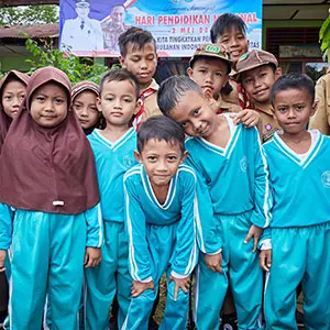 A group of kids in blue clothings posing for the photo