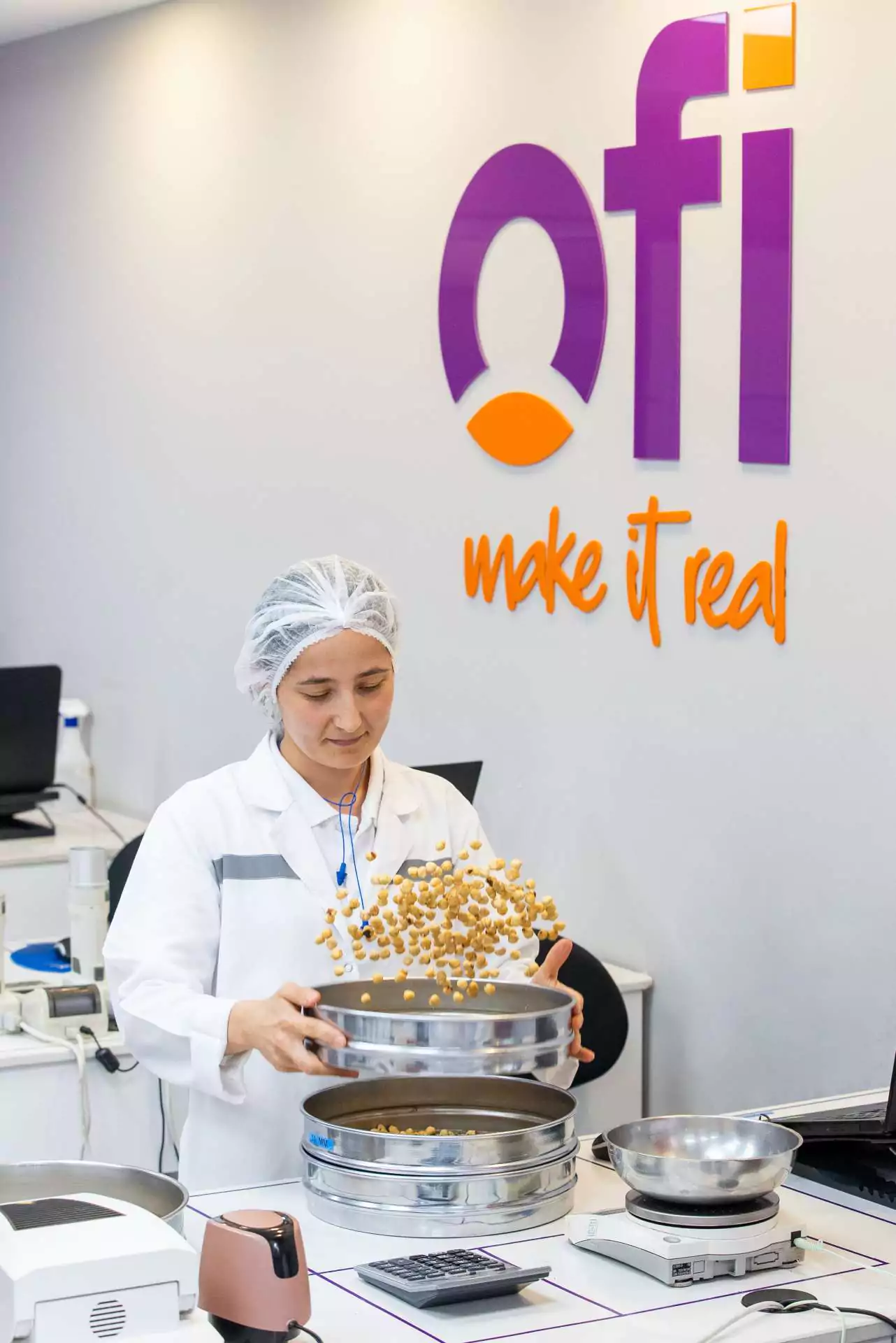 Worker at Ofi tossing hazelnuts in the air