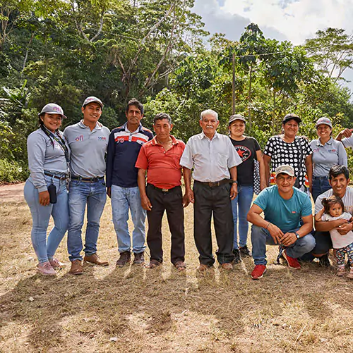 Group of people taking a group picture in front of a forest