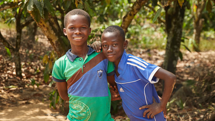 Two boys posing in a forest