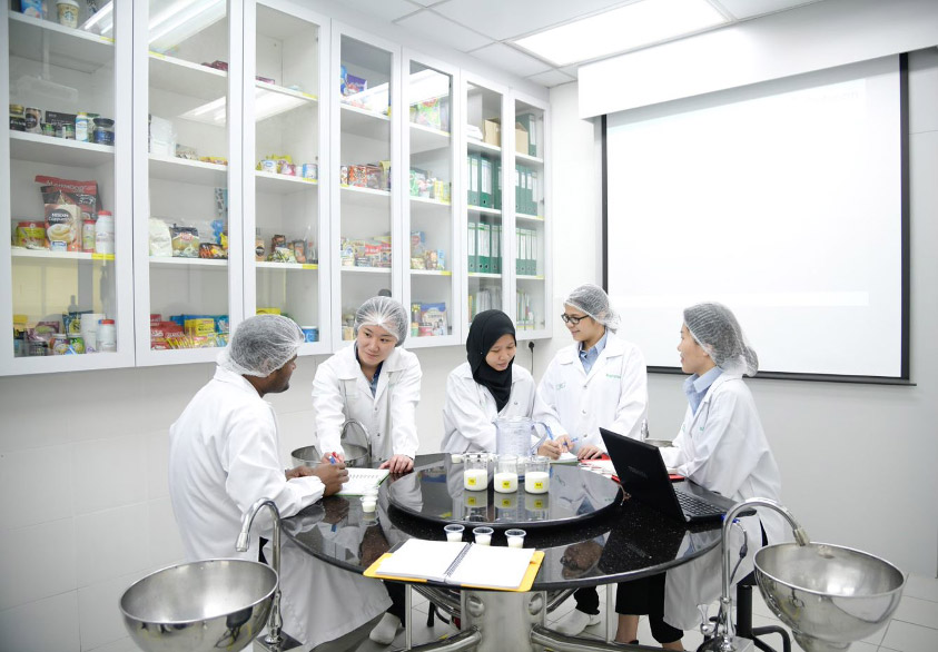 Group photo a lab technicians sitting together and discussing
