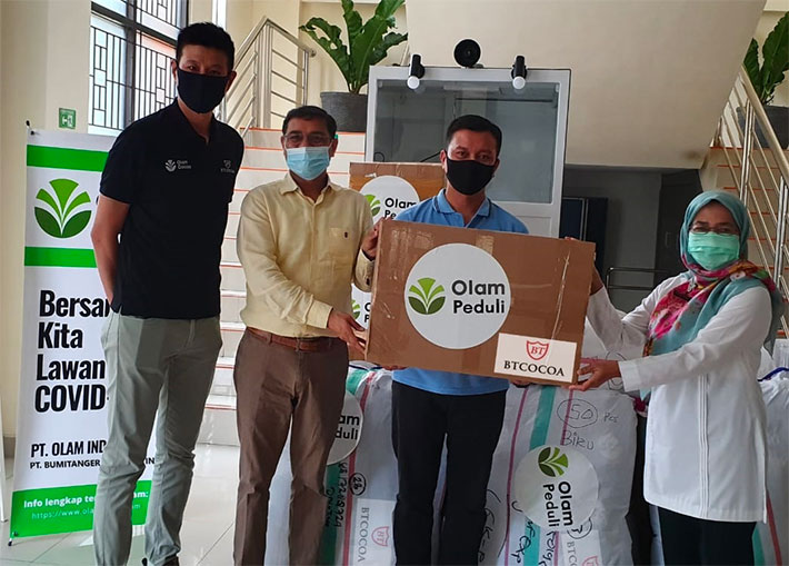 Group photo of three Indonesian men and a woman receiving a donation