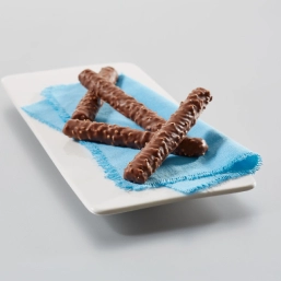 A person eating chips with chopsticks