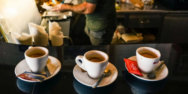 Three espresso cups filled with fresh coffee