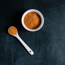 A small bowl filled with garam masala spice mix