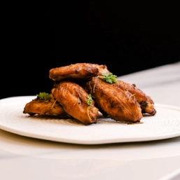 A plate filled with chicken wings