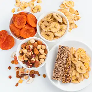 Different snacks, such as dried fruit, nuts and granola bars