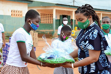 Woman gifting a girl a package