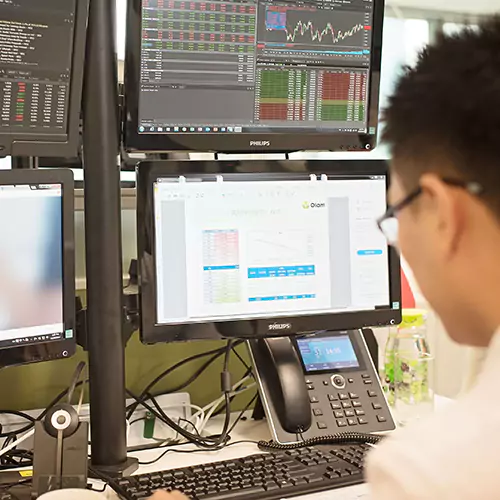 Man sitting behind the computer looking at tables