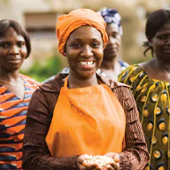 Smiling woman holding a handful of nuts
