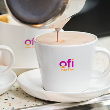 coffee being pourd into ofi coffee cup
