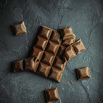 Chocolate bar with crumbled pieces around it
