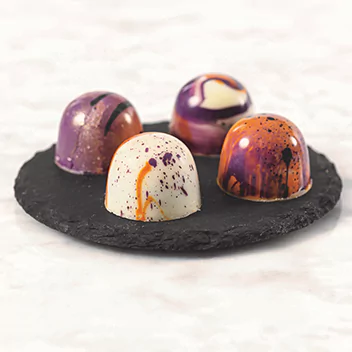 Four colorful pralines
