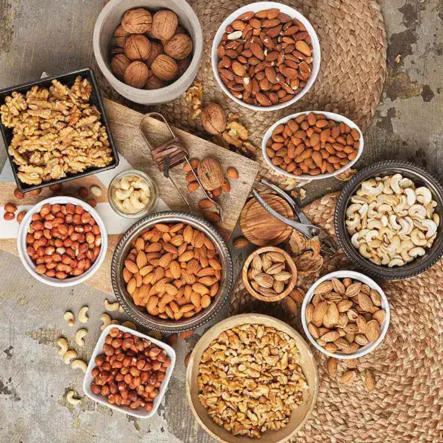 Flat lay of various nuts ranging from almonds and cashew nuts to pecan and Brazilian nuts