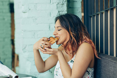 Woman eating a croissant