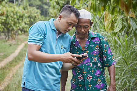 Two men looking at something on a mobile device