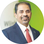 Close-up photograph of A. Shekhar's face on a green background 
