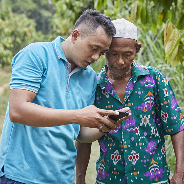 Two men looking at something on a mobile device