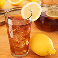 Cold beverage with ice cubes, topped with a lemon slice