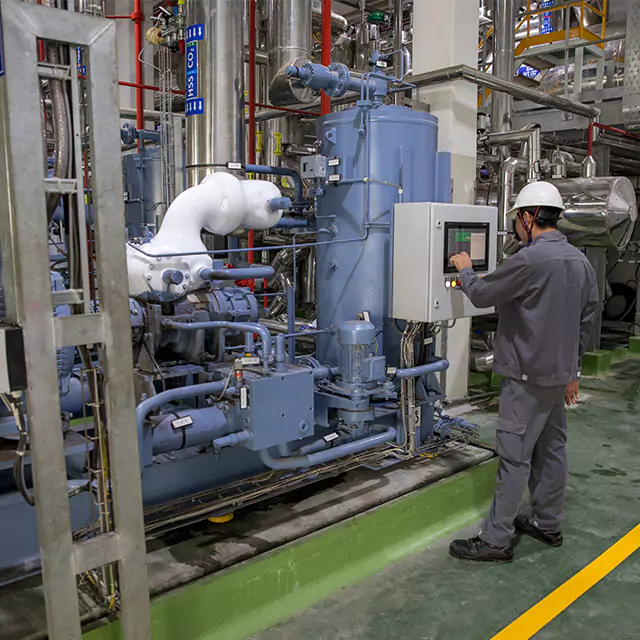 Facility photo of a male worker checking the system at the processing facility cafe