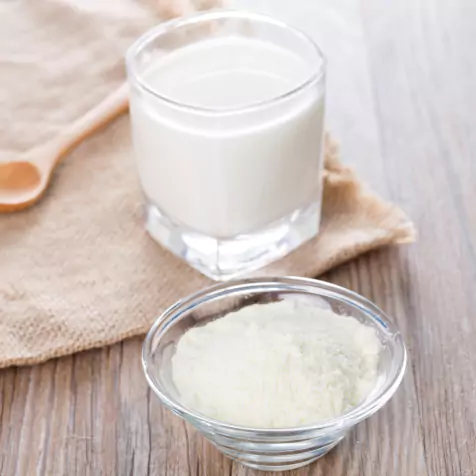 Milk powder and glass of milk