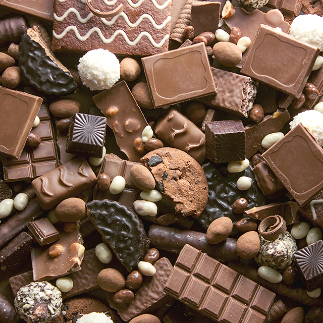 Close up shot of different chocolate pieces and cookies