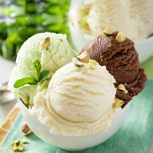 Close up shot of three scopes of ice cream in a white bowl