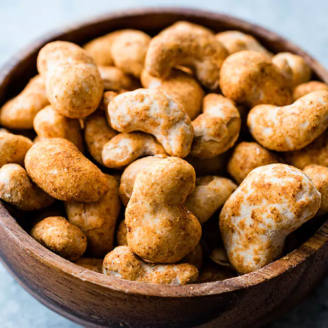 Close up shot of flavored cashews in a bowl