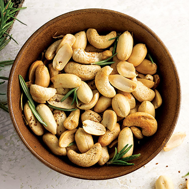Close up shot of cashews sprinkled with rosemary