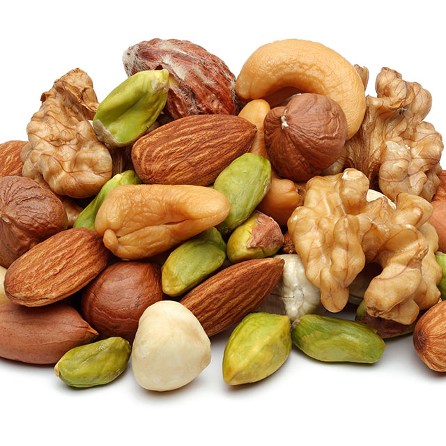 Close up shots of different types pistachios, walnuts, almonds and cashews