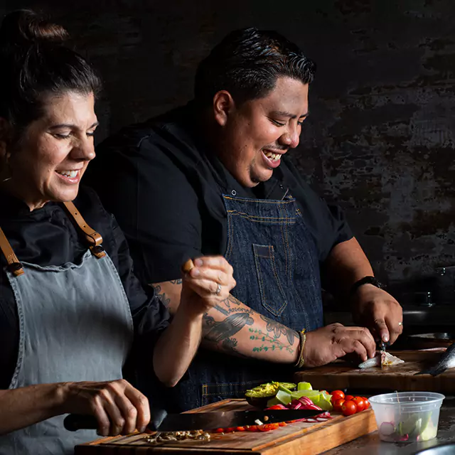 Two chefs preparing food