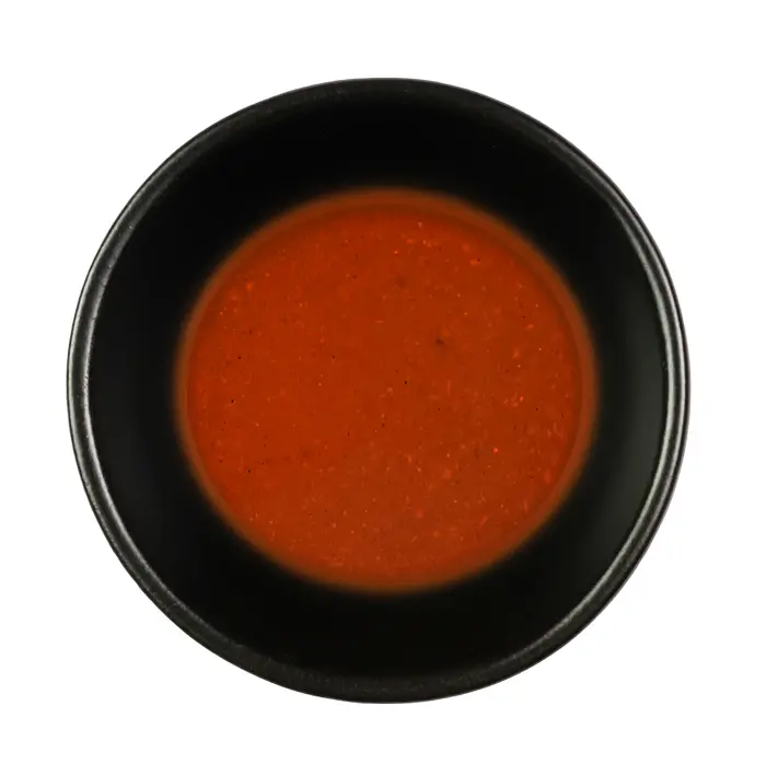 Red liquid in a black bowl