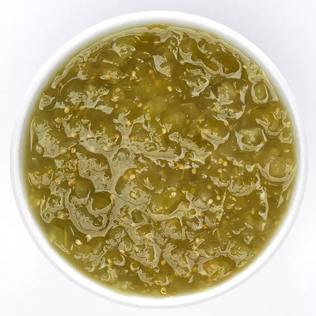Close up shot of green crushed tomatillos
