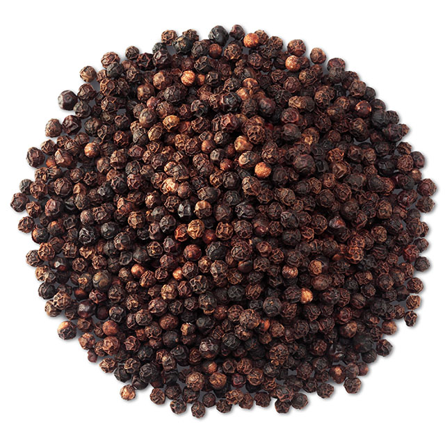 Close up shot of whole black pepper kernels