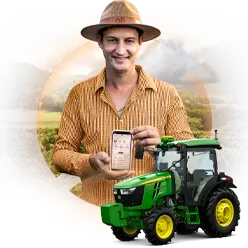 Two farmers standing by a green tractor with a colorful background.